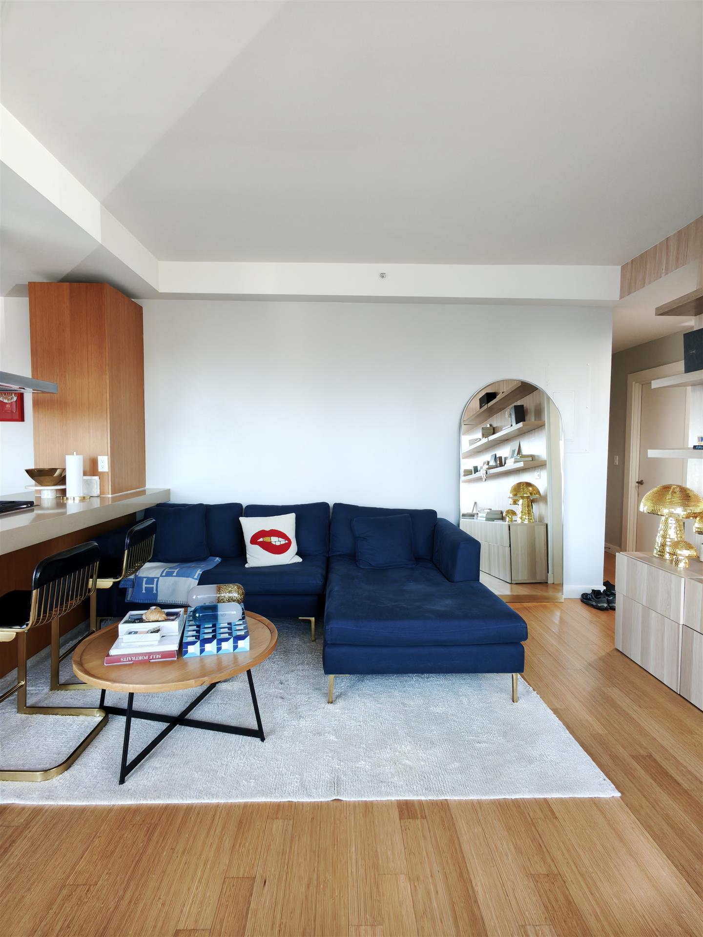Sky25 Chelsea living room with blue sofa and colorful art